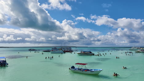 Boat-Tour-With-Tourists-At-Swimming-Spot-With-Clear-Waters-In-Summer-In-Dominican-Republic