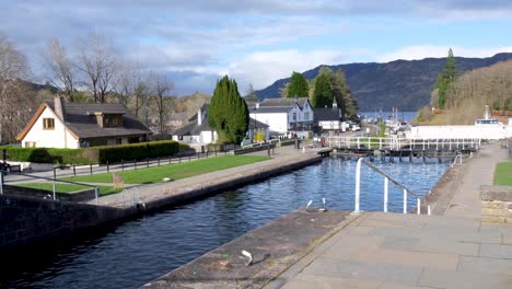 Scenic-view-of-Caledonian-Canal,-locks-and-swing-bridge-looking-towards-Loch-Ness-in-Fort-Augustus-in-the-highlands-of-Scotland-UK