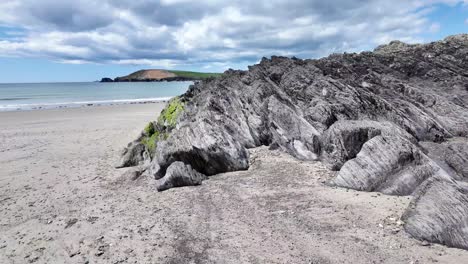 Beautiful-stone-formation-on-a-sandy-beach-in-West-Cork,-Owenahincha
