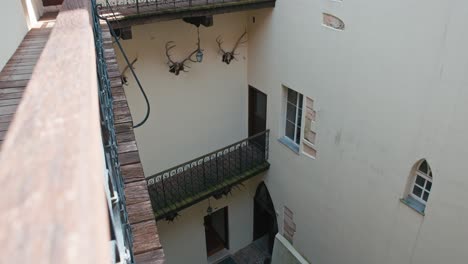 view-of-balconies-with-antler-mounts-in-the-courtyard-of-Trakošćan-Castle,-Croatia