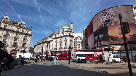 On-a-sunny-morning,-Red-Double-Decker-Buses-Passing-Through-Piccadilly-Circus-in-London