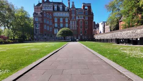 POV-Walking-Through-Abingdon-Gardens-In-Westminster-With-Millbank-House-In-Background-On-Sunny-Morning