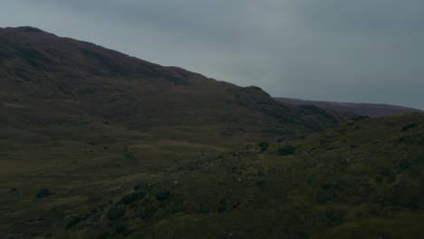 Low-dolly-in-flight-in-the-Highlands-of-Isle-of-Mull,-Scotland-reveals-a-lush-green-mountainous-landscape