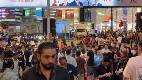 People-scrambling-crossing-at-the-famous-Shibuya-style-intersection-in-the-bustling-Bukit-Bintang,-Kuala-Lumpur,-Malaysia