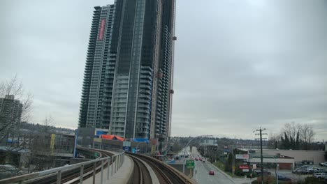 Skyscraper-Along-Railroad-Bridge-On-A-Cloudy-Day-In-Vancouver,-British-Columbia,-Canada