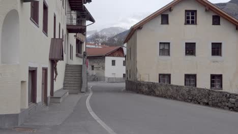 Part-of-the-main-street-in-Laatsch---Laudes,-Vinschgau,-South-Tyrol,-Italy-on-a-windy-day