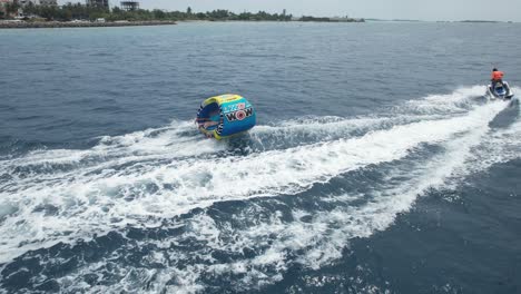 Water-Tubing-Fun-and-Beach-Holiday-Activities,-Drone-Follow-Shot