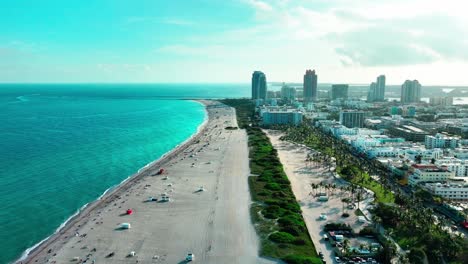 Flying-over-Nikki-Beach-night-club-in-Miami-South-Beach-Florida-on-a-cloudy-day-at-dusk-aerial-view