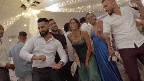 Slow-motion-shot-of-attractive-wedding-guests-dancing-and-having-fun