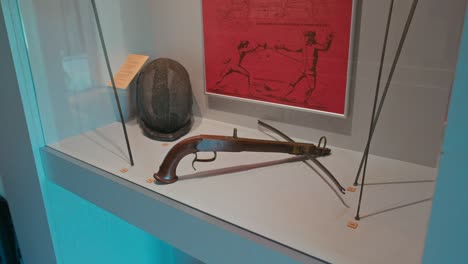 Historic-firearm-and-helmet-display-in-the-weapon-room-of-Trakošćan-Castle,-Croatia