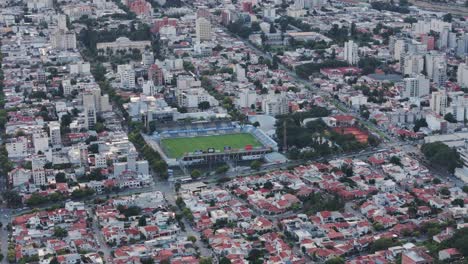 Aerial-Tracking-Football-Stadium-Estadio-el-Gigante-del-Norte-Centered-Among-Capital-City-Salta,-Argentina