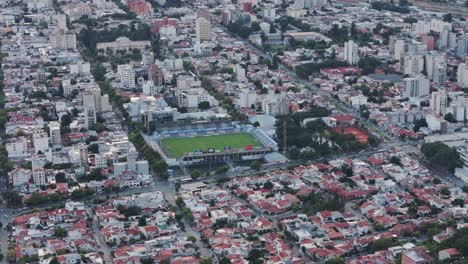 Aerial-Tracking-Football-Stadium-Estadio-El-Gigante-Del-Norte-Centered-Among-Capital-City-Salta,-Argentina