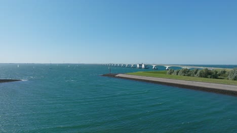 Aerial-shot-of-the-famous-Zeeland-bridge-during-a-sunny-day