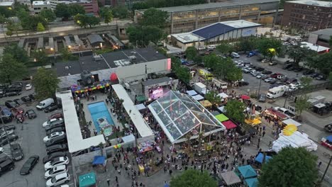 A-Large-Gathering-of-People-Assembled-Tents-and-Crowded-the-Streets-at-the-Fair-City-Event-in-Downtown-Atlanta,-Georgia,-USA---Aerial-Drone-Shot