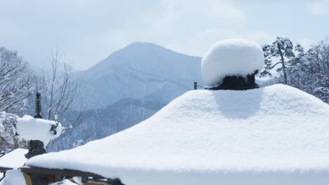 Snow-covering-Japanese-Temple-Roof,-Yamadera-in-Northern-Tohoku-Japan