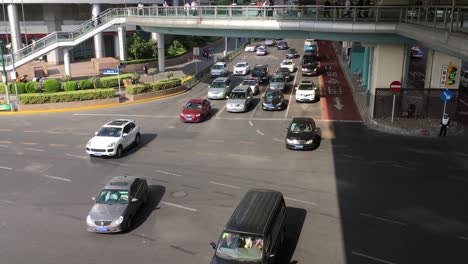 Intersection-in-Pudong,-Shanghai,-China-with-driving-cars-and-lot-of-traffic-lanes-under-bridge