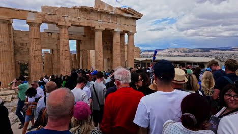 Athens,-Greece:-Shot-of-group-of-tourists-visiting-an-ancient-monument-of-Agrippa-in-Greece-dedicated-to-the-goddess-Athena-on-a-cloudy-day