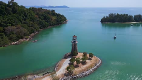 Solitary-lighthouse-on-headland-with-scenic-tropical-beach