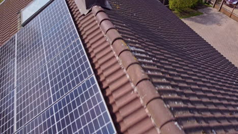 Close-Aerial-Row-Consumer-Solar-Panels-on-Residential-Building,-Making-House-More-Sustainable