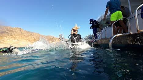 A-Scuba-Diver-Leaping-Into-the-Water-From-the-Boat-in-Dahab,-Sinai-Peninsula,-Egypt---Slow-Motion