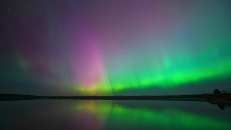 Aurora-explodes-over-a-lake-as-an-intense-solar-storm-impacts-the-area