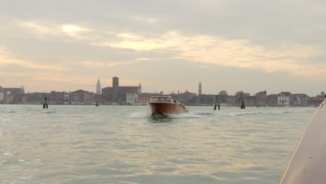 Punto-De-Vista-De-Un-Turista-Montando-Un-Taxi-Acuático-Sobre-La-Laguna-Durante-La-Puesta-De-Sol-En-Venecia,-Italia