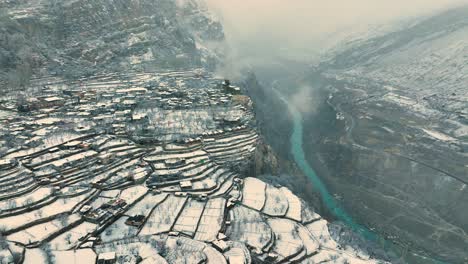 Aerial-view-of-snow-covered-area-of-Karimabad-in-Hunza,-Pakistan