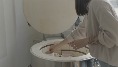 a-female-ceramicist-loading-the-kiln