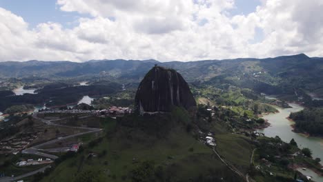 Large,-unique-mountain-El-Peñón-in-Guatapé,-Colombia,-aerial-orbit-panorama-view