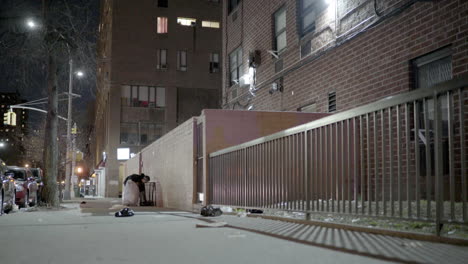 Woman-Checks-Garbage-Can-for-Recyclable-Items-in-East-Harlem-New-York-City