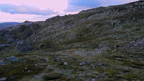 Empty-pommel-surface-ski-lift-during-dry-off-season-aerial-surrounded-by-rocks-at-Thredbo,-Snowy-Mountains,-NSW,-Australia