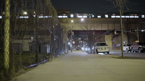 Empty-East-Harlem-Street-at-Night-with-Elevated-Train-Passing-Overhead