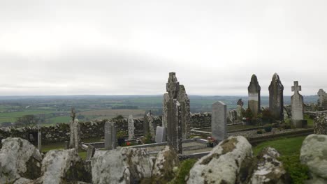 Ancient-cemetery-with-medieval-tombstones-at-the-Hill-of-Slane,-overlooking-lush-Irish-landscape