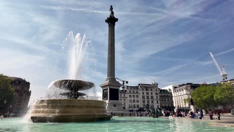 Sunny-Morning-View-Of-Water-Coming-Out-Of-The-Fountain-At-Trafalgar-Square-With-Nelson's-Column-In-Background