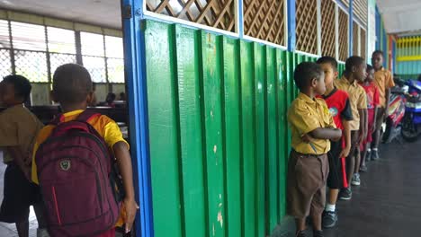 Asian-Indonesians-children-entering-classroom-in-rural-gymnasium-school