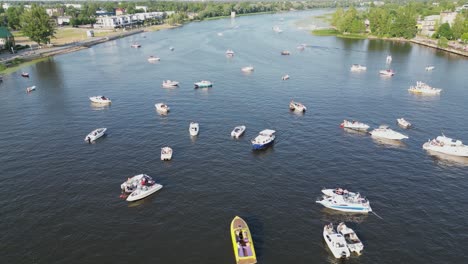 Boats-assemble-on-river-in-picturesque-Parnu,-Estonia-for-summer-fest