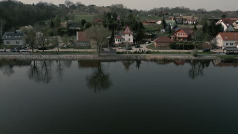 Aerial-View-Of-Cars-Driving-In-The-Road-Along-Odra-River-In-Siadlo-Dolne-Village-In-Poland