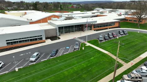 Parking-cars-with-American-flag-in-front-of-American-elementary-school