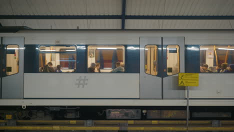 People-sitting-in-train-and-one-arrives-while-the-other-one-leaves