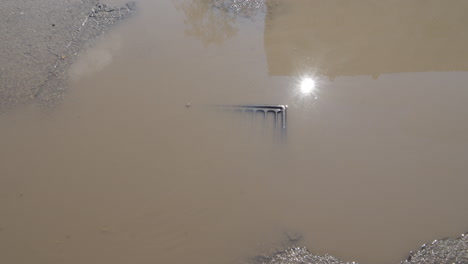 Flooded-rain-water-drainage-in-broken-city-street