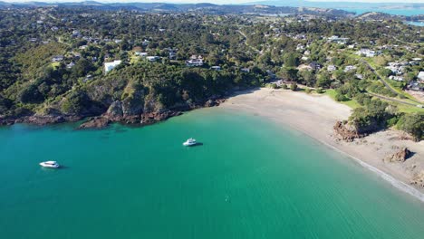 Boats-On-Turquoise-Bay-Of-Oneroa-Off-The-Shore-Of-Little-Oneroa-Beach-In-Auckland,-New-Zealand