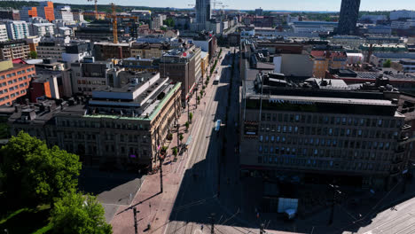 Aerial-view-circling-a-bus-on-the-streets-of-Tampere,-summer-day-in-Finland