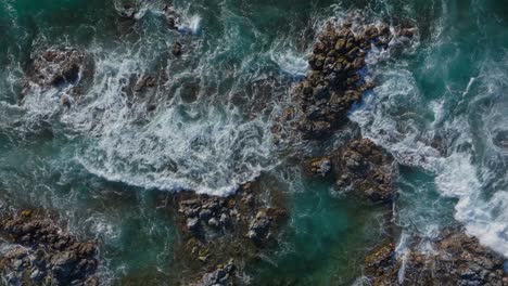 Ho'okipa-surf-break-waves-crashing-against-rocky-coastline-in-maui,-aerial-view