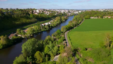 Country-road-along-Vienne-river-with-Limoges-city-in-background,-France