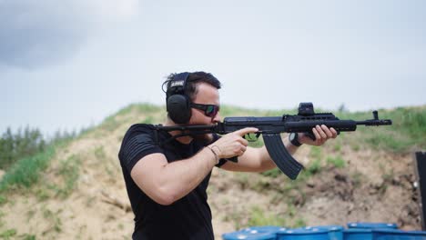 Person-hold-and-aim-CZ-858-tactical-automatic-rifle-at-Olesko-shooting-range
