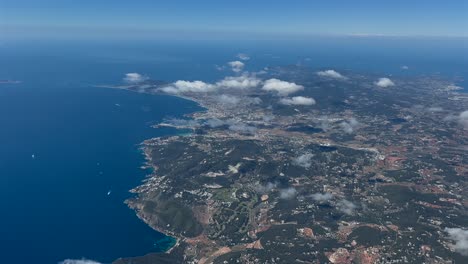 Aerial-panoramic-view-of-Ibiza-Island-and-city,-shot-from-an-airplane-departing-from-the-airport-in-a-splendid-sunny-spring-morning