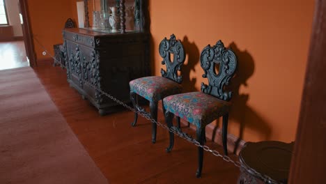 Ornate-antique-chairs-and-wooden-cabinet-in-the-Neoclassical-Room-of-Trakošćan-Castle,-Croatia