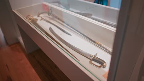 Display-case-of-antique-swords-in-the-weapon-room-of-Trakošćan-Castle,-Croatia