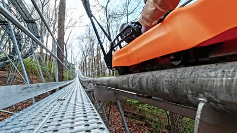 Aerie's-Alpine-Coaster-in-Grafton-Illinois-Being-Pulled-Uphill-with-a-Low-Angle-Shot-Alongside-the-Toboggan,-USA