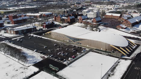 Kvibergs-Parks-ice-hall-and-sport-hall-in-Gothenburg-at-winter,-Aerial-Establishing-shot